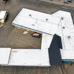 Restored white TPO roof after replacement, aerial