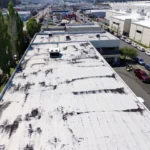 Aged commercial roof before overlay, 3/4 view