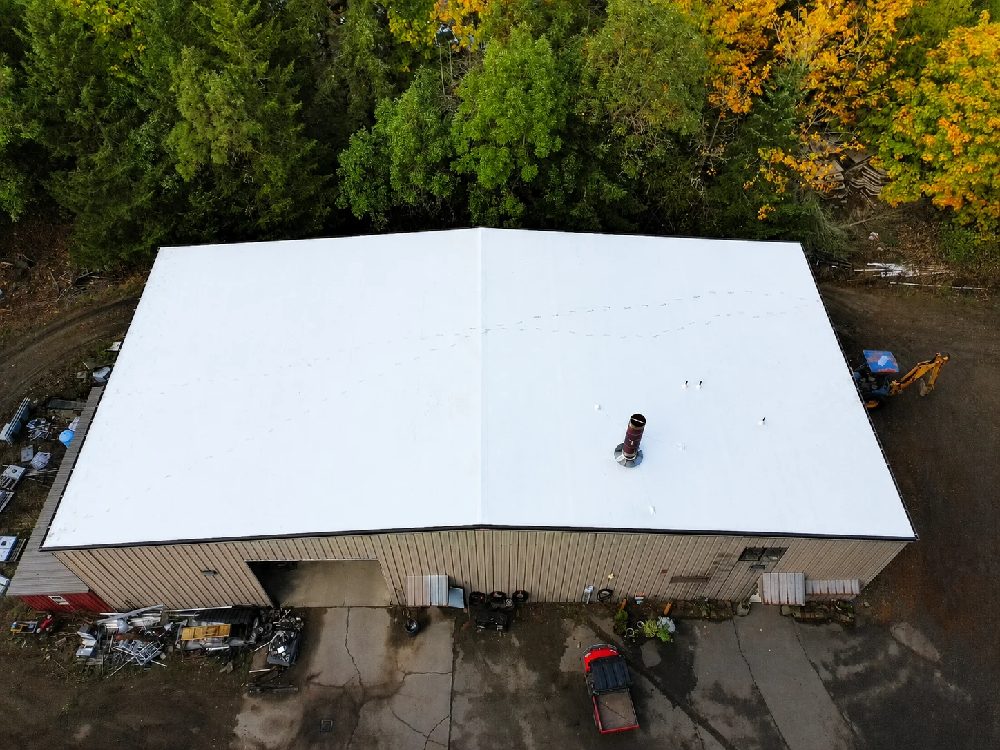 Liquid-applied commercial roof coating restoring an existing roof